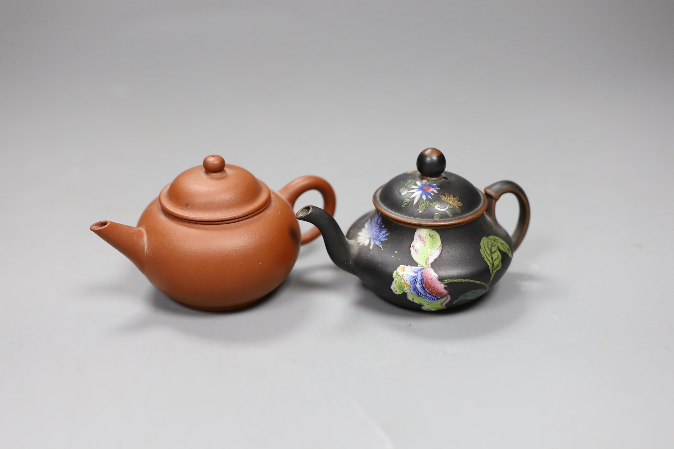 A Chinese Yixing miniature teapot and a Wedgwood enamelled black basalt miniature teapot, 6cm high